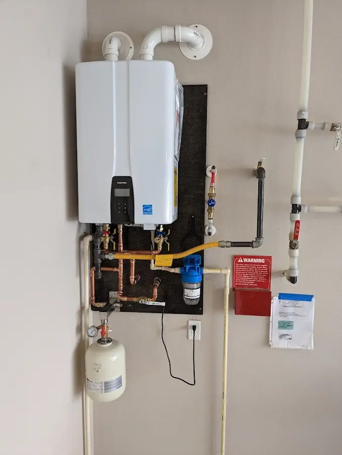Professional plumber installing copper piping in a Closter home
